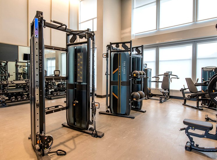 apartment gym with large windows and workout machine equipment